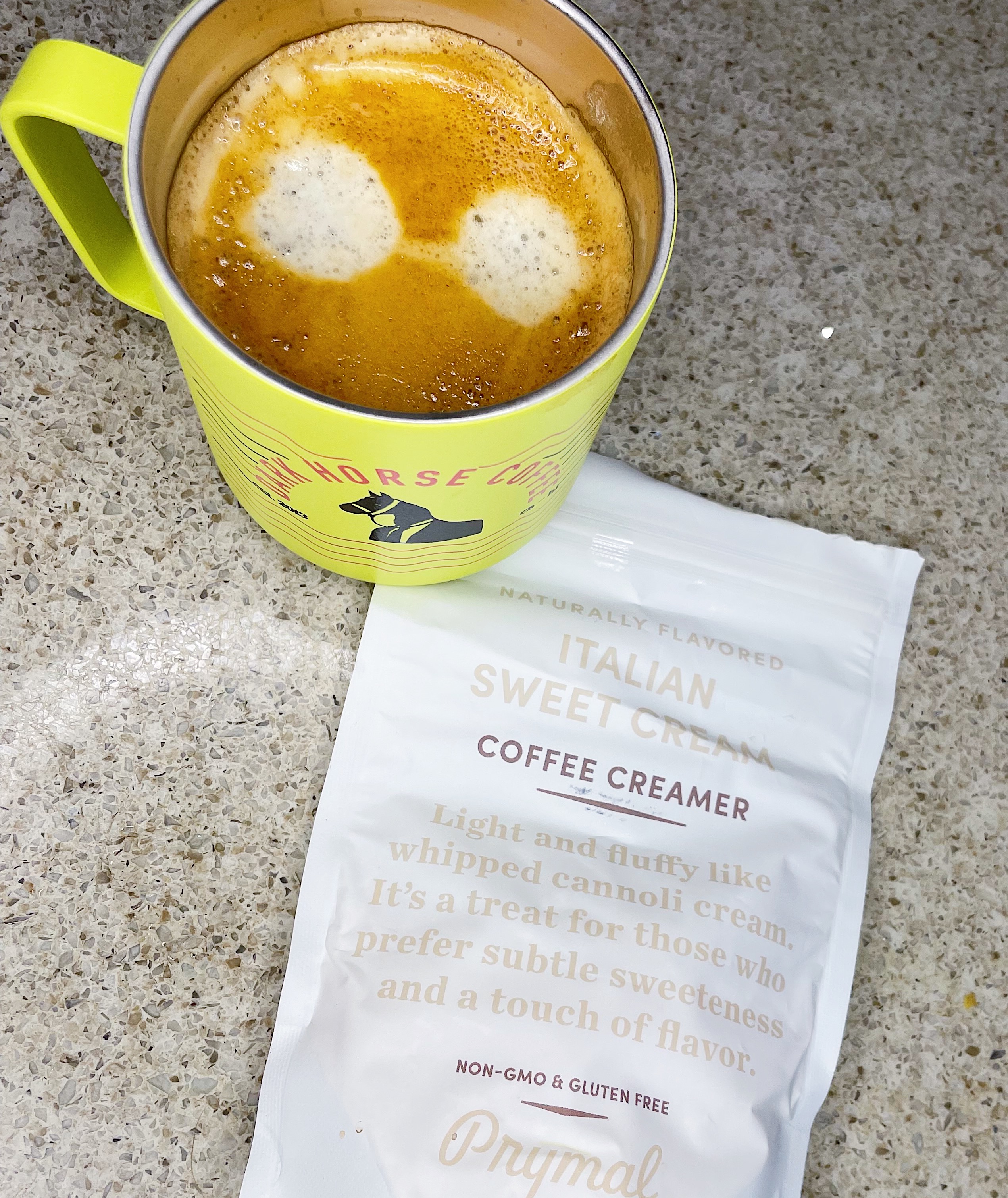 Healthy, keto-friendly coffee creamer alternative Prymal creamer, next to a cup of coffee