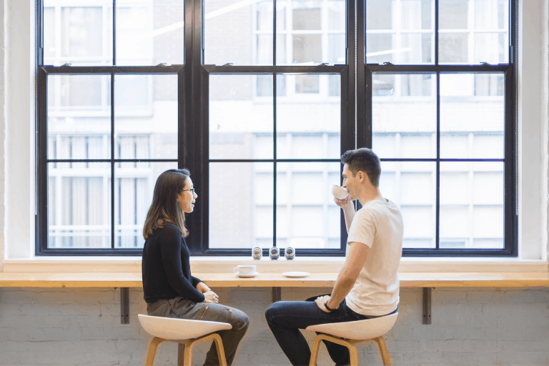 Man and woman sitting down for coffee