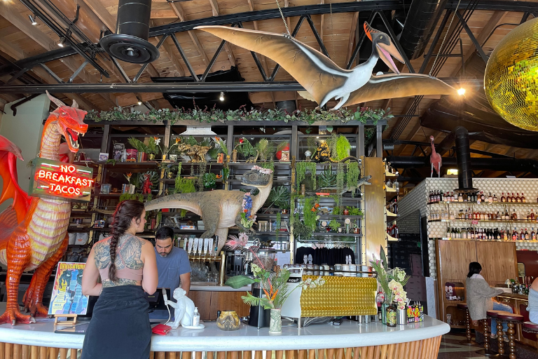 Interior of San Diego coffee shop The Invigatorium, with eclectic decor including a pterodactyl statue