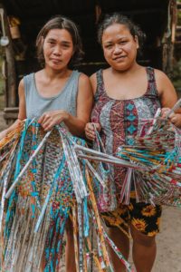 Two women in the Philippines using upcycled plastic to handweave the pieces into sustainable purses